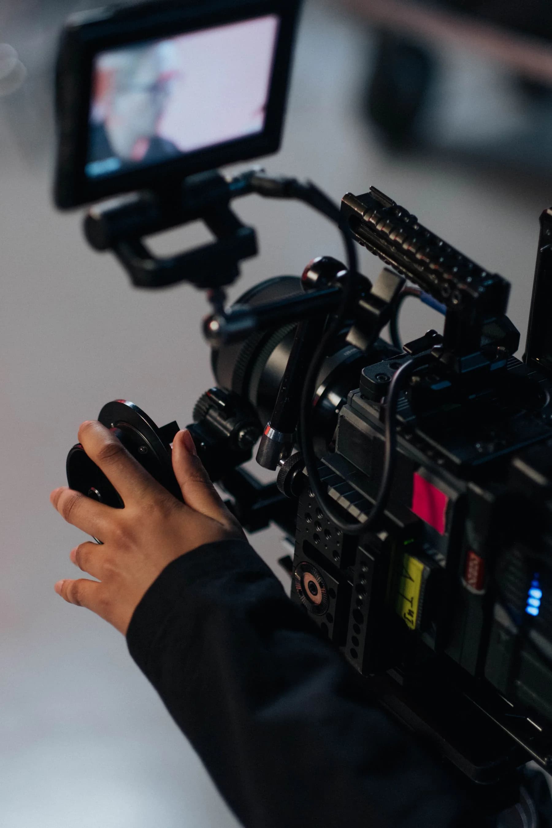 A filmmaker operating a cinema camera on set